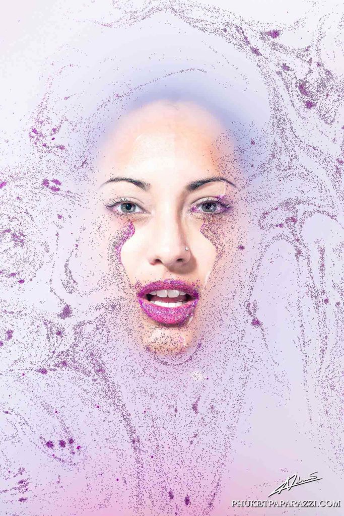 Fantasy photography womans face in milk bath with glitter.