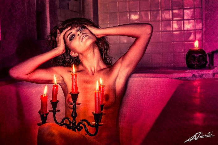 Nude photography woman with candles in the bath.
