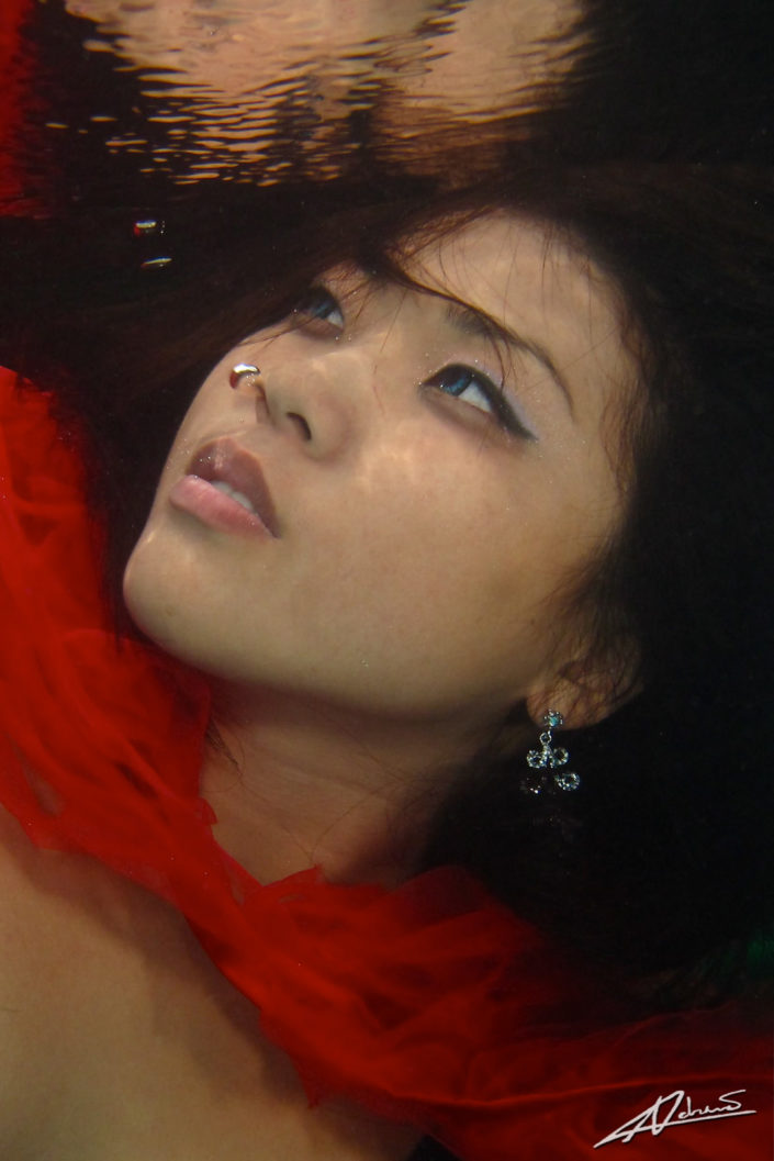 Underwater portrait woman close up shot.