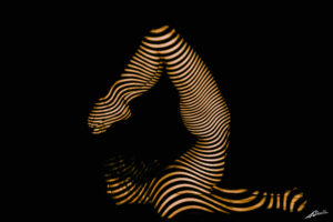 Projections-nude photography woman in scorpio yoga pose and yellow curves pattern.